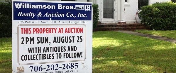 This property at auction: Williamson Bros. sign in front of a home